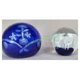 Two blue glass paperweights