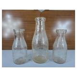 Three Vintage milk bottles