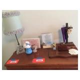 Lamp, decorators & assorted on top of dresser.