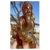 CARVED FIGURINE NETSUKE - AMBER ? RESIN ?