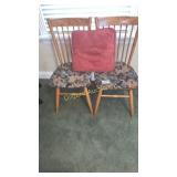Two wooden chairs with cushion