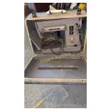 Portable Singer sewing machine in case