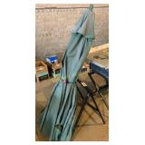 Patio umbrella and one saw horse