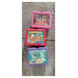 Garfield, lambchop, and barbie lunch boxes