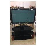 Panasonic 42 inch tv on three shelf stand.