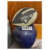 Football and vase filled with balls