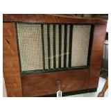 Vintage radio and record player in cabinet