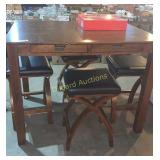 Wooden high top table with four padded stools