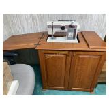 White sewing machine in cabinet