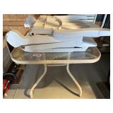 (3) Plastic patio chaise loungers, glass top table