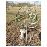 Metal whirly gig, concrete pedestal