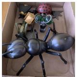Metal insects and little wooden birdhouse