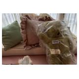 Throw pillows and old teddy bear
