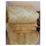 Yellow blankets, comforter, bath mats, more