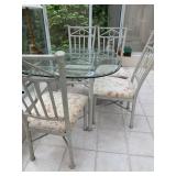Glass top patio table with 4 padded chairs