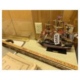 Model British ship, walking cane, and yard stick