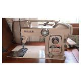 White sewing machine in table