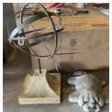 Sun dial and stone laying dog