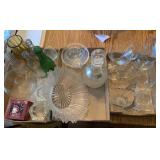 Candles, bottles, glassware, glass basket.