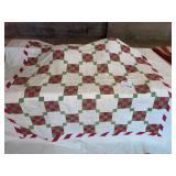 Red and green quilt somewhere on green