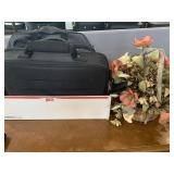 Brief cases and artificial flowers