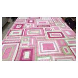 Pink and White pieced and ribbon decorated quilt