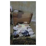 Sewing material in vintage suitcase