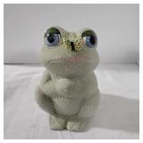 Cute textured frog with a butterfly on its nose