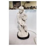 Ceramic lamp of a kid and his dog.