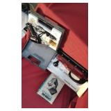 Soldering gun, slide viewer, line sander.