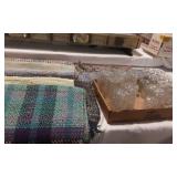 A variety of throw rugs and crystall glasses
