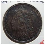 1887 Morgan silver dollar. GEM BU toned.