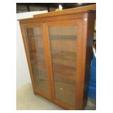 Antique oak four tier glass front cabinet.