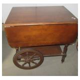 Wood double drop leaf tea cart on castors. Wood double drop leaf tea cart on castors.