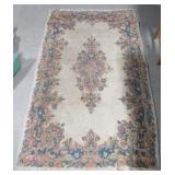 Area rug. Measures 60" x 36". Shows wear. Area rug. Measures 60" x 36". Shows wear.