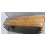 Wood bench. Measures 17.5" h x 59" w x 13" d.