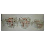 (3) Pyrex glass measuring cups. (3) Pyrex glass measuring cups.