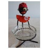 Black memorabilia ashtray with metal stand.