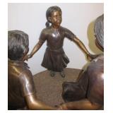 Bronze children playing ring around the rosie.
