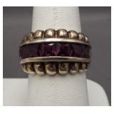 Sterling silver ring featuring purple stones.