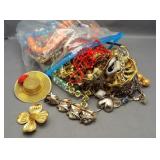Bag of costume jewelry necklaces, pins,