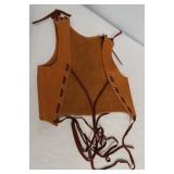 Leather vest with graphic woman on back. Measures