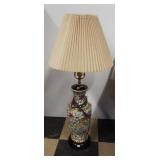 Ceramic floral design electric lamp with shade.
