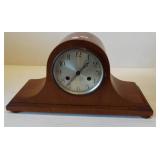 Vintage wood cased mantel clock. Measures 9" h x