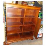 Cherry wood colored eight section book shelf.