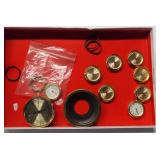 Various clock parts and thermometer piece. Brands