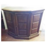 Vintage wood cabinet featuring center door with