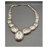 Unique silver colored costume necklace. Measures