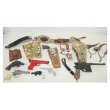 Vintage toy cap guns and holders that includes