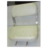 Padded boat seat with folding back.